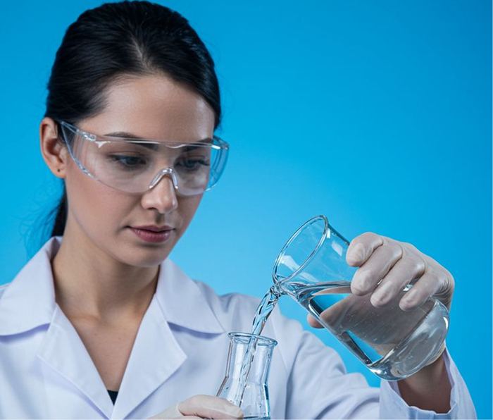 Laboratory technician verifying ethanol quality